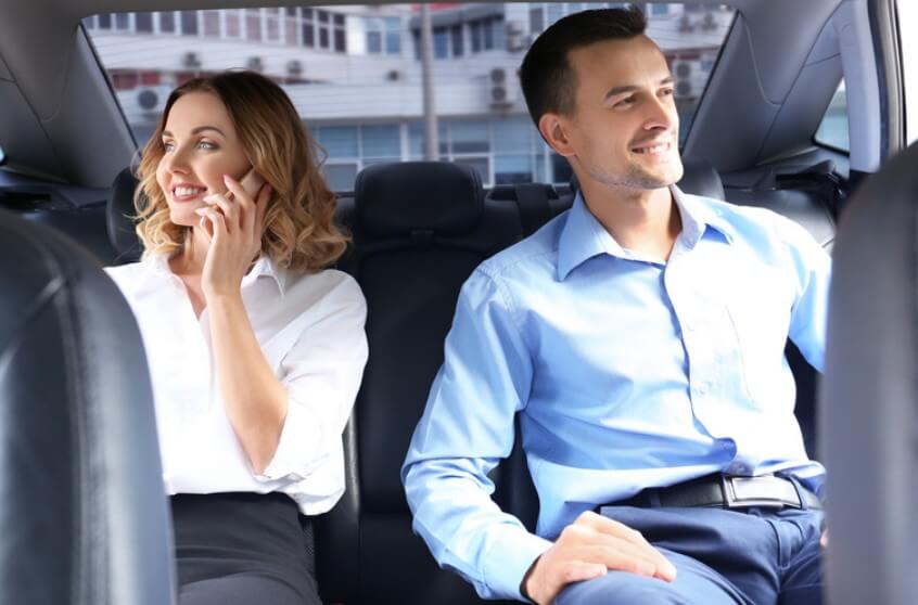 Business travelers enjoying a comfortable ride with KLEO Black Car Service in Atlanta